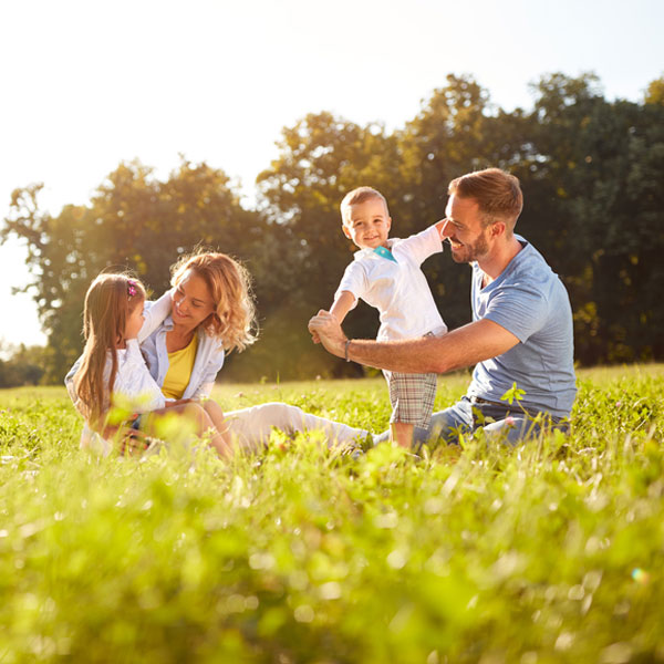 Happy family in field during Summertime